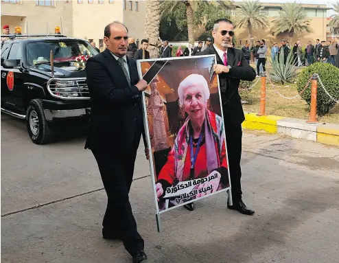  ?? KHALID MOHAMMED / AP PHOTO ?? Mourners transport the flag-draped coffin of Iraqi archeologi­st Lamia al-Gailani for burial during her funeral procession in the National Museum in Baghdad on Jan. 21.