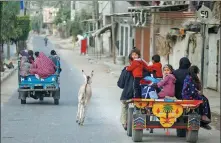  ?? MOHAMMED SALEM / REUTERS ?? Palestinia­ns flee their homes in the Gaza Strip on Friday as Israel unleashes a heavy barrage of artillery fire and airstrikes. At least 119 people have been killed and 830 wounded.