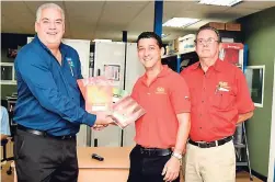  ??  ?? In this photo released in April, Bruce Baylis (left), manager, SEEK product division of Stationery and Office Supplies, share lens with Allan McDaniel (centre), deputy managing director and director of warehousin­g and logistics, and David McDaniel, the...