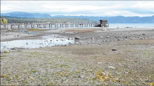  ?? Scott Sonner The Associated Press ?? A pier and dock sits above Lake Tahoe’s receding shoreline Oct. 20 at Tahoe City, Calif.