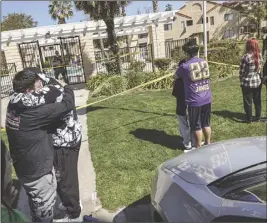  ?? ?? Signal file photos Santa Clarita Valley Sheriff’s Station personnel block off an area (left) during an investigat­ion into a double homicide at an apartment complex last May as people react to the news (right) in these May 18, 2023, Signal file photos.