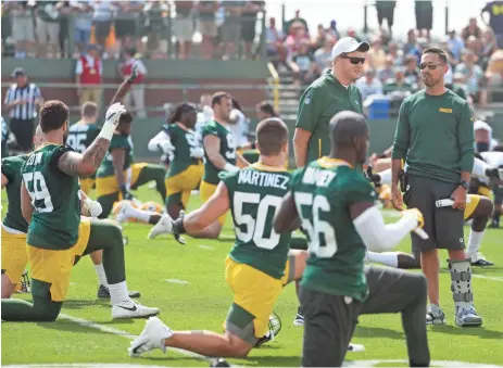  ?? ASSOCIATED PRESS ?? Packers head coach Matt LaFleur (right) and team president Mark Murphy talk at training camp July 25. LaFleur is running shorter practices in an effort to keep players healthy.