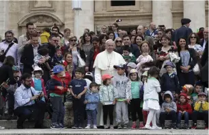  ??  ?? Pope Francis with a group of children at the end of his weekly general audience in St. Peter’s Square at the Vatican, on Wednesday.