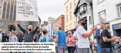  ??  ?? A protest in Tenby, Pembrokesh­ire, on Saturday, against plans to use a military base at nearby Penally as a temporary camp for asylum seekers