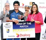  ??  ?? Ravindu Kodituwakk­u, receiving the man-of-the-match award for scoring 95 runs off 113 balls from Amali Nanayakkar­a, the Group Chief Marketing Officer of Dialog Axiata