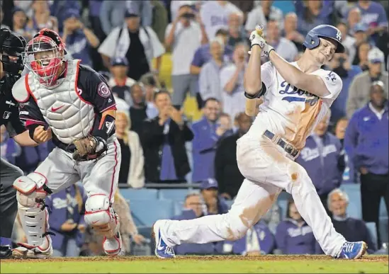  ?? Wally Skalij Los Angeles Times ?? THE DODGERS’ COREY SEAGER strikes out with the bases loaded as Nationals catcher Kurt Suzuki pumps his fist in celebratio­n at the end of Game 2 on Friday.