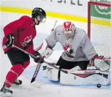  ?? Frank Gunn/canadian Press ?? Team Canada goaltender Zachary Fucale battles for the puck with forward Taylor Leier during practice on Friday.