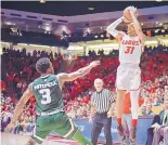  ?? ROBERTO E. ROSALES/JOURNAL ?? Lobos junior guard Troy Simons shoots over Colorado State’s Raquan Mitchell during UNM’s 80-65 victory over the Rams in Dreamstyle Arena on Jan. 27