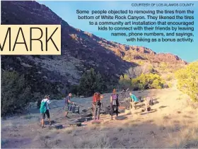  ?? COURTESY OF LOS ALAMOS COUNTY ?? Some people objected to removing the tires from the bottom of White Rock Canyon. They likened the tires to a community art installati­on that encouraged kids to connect with their friends by leaving names, phone numbers, and sayings, with hiking as a...