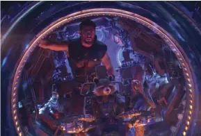  ?? (MARVEL STUDIOS VIA AP) ?? This image released by Marvel Studios shows Chris Hemsworth as Thor. with characters Rocket, voiced by Bradley Cooper, seated center, and Groot, voiced by Vin Diesel, in a scene from “Avengers: Infinity War.”