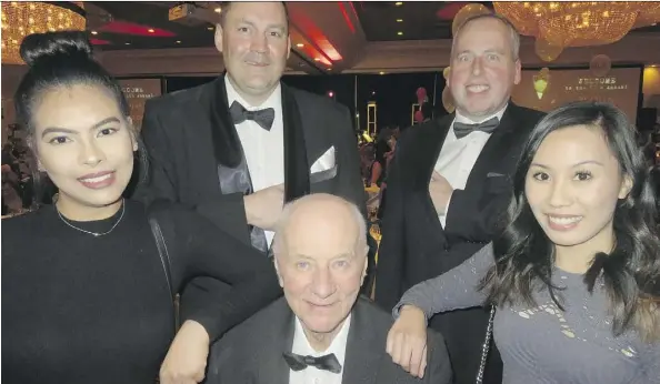 ?? NICK LEES ?? Philanthro­pist Frank Flaman, centre, attends his foundation’s James Bond themed party Friday night at the Fantasylan­d Hotel with, back left, foundation GM Rocky Amson and Edmonton Eskimos President and CEO Len Rhodes. The “Bond girls” are Apole...