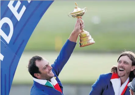  ?? ALASTAIR GRANT/THE ASSOCIATED PRESS ?? Europe’s Francesco Molinari holds up the Ryder Cup following his team’s decisive win in France Sunday.