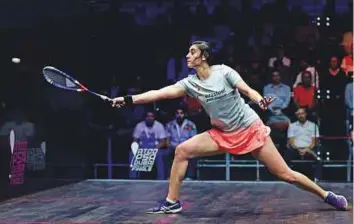  ?? AP ?? Nour Al Sherbini returns a shot during her victory over Joelle King of New Zealand in the first ■ round of the Dubai World Series Finals. The Egyptian star has booked a spot in last four.