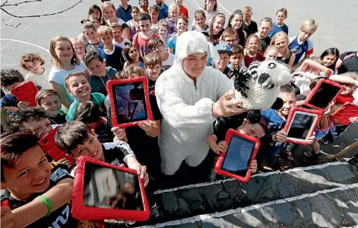  ?? MARTIN DE RUYTER ?? Nuka Ririmui dressed as Woolly the sheep to help out Nelson College Lion Foundation Young Enterprise Scheme students with their Where’s Woolly project at Hampden Street School.