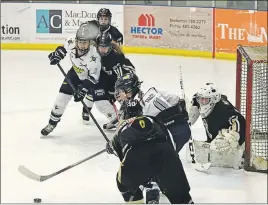  ?? SUBMITTED ?? Graduating players Katie Pentz and Patti-Anne Tracey of the Northern Subway Selects try to get the puck past the East Hants ProCrestin­g Penguins goalie on Saturday night at the Pictou County Wellness Centre in game one of the best-of-five semi-final...