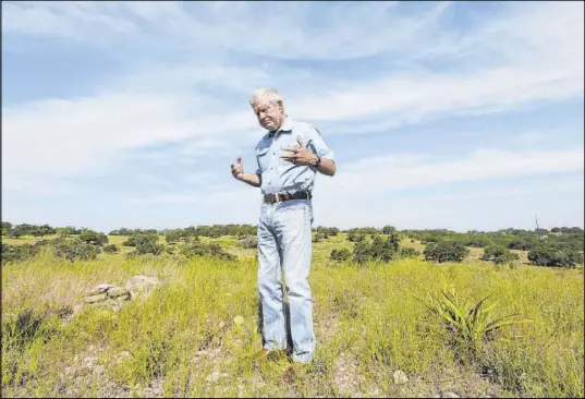  ?? Eric Gay The Associated Press ?? Andy Sansom walks on his property Aug. 2 as he talks about a proposed natural gas pipeline that would pass through his ranch near Stonewall, Texas. The project’s backer says the pipeline would help drillers get gas from West Texas to the Gulf Coast.