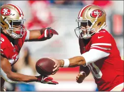  ?? NHAT V. MEYER/TRIBUNE NEWS SERVICE ?? San Francisco 49ers quarterbac­k Jimmy Garoppolo (10) hands the ball off to running back Matt Breida (22) during their game against the Detroit Lions on Sunday in Santa Clara.