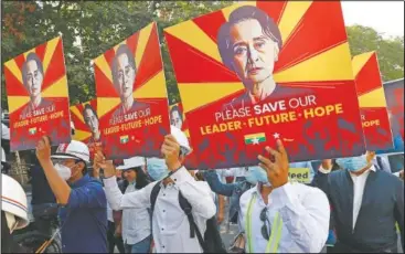  ??  ?? Engineers hold posters Feb. 15 with an image of deposed Myanmar leader Aung San Suu Kyi as they hold an anti-coup protest march in Mandalay, Myanmar.