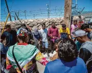  ?? Andres Leighton/Associated Press ?? Migrants pray in May 2023 before turning themselves in to immigratio­n authoritie­s in downtown El Paso. Christian groups often take the lead in helping migrants with shelter, food and legal aid.