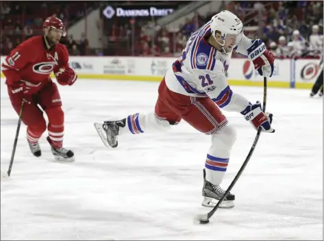  ??  ?? In this March 9 file photo, New York Rangers' Derek Stepan (right) shoots as Carolina Staal watches during the first period of an NHL hockey game in Raleigh, N.C. AP PHOTO