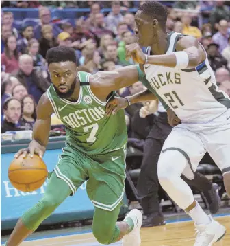  ?? AP PHOTO ?? A NEW ERA: Jaylen Brown drives on the Bucks’ Tony Snell during a regular-season game earlier this month. The Celtics return to Milwaukee in the postseason for the first time since 1987 for tonight’s Game 3 at the Bradley Center.