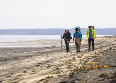  ?? Photos by Egill Bjarnason / Associated Press ?? Hikers take an early morning trek on the Hornstrand­ir peninsula, where some want to keep the internet out.