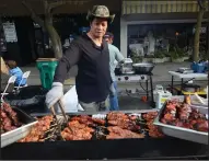  ?? LISA JAMES/NEWS-SENTINEL FILE PHOTOGRAPH ?? Emmet Dumayag grills chicken skewers for a hungry crowd on opening night of Lodi’s annual Farmers Market on May 19, 2016.