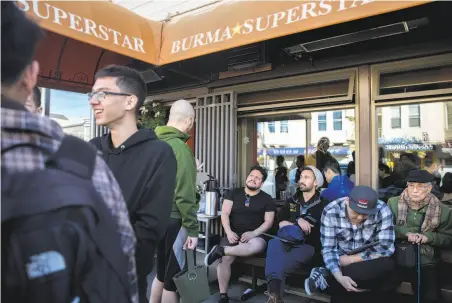  ?? Photos by Jessica Christian / The Chronicle ?? Above: Diners wait for a table at Burma Superstar in the Richmond District. While it is easier to secure money to open new restaurant­s in San Francisco, rising minimum wages and rents add to the costs.