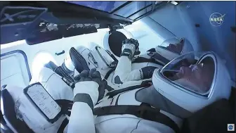  ?? NASA TV / AGENCE FRANCE-PRESSE ?? In this still image taken from NASA TV before liftoff, NASA astronauts Bob Behnken (rear) and Doug Hurley are strapped in the SpaceX Crew Dragon capsule.