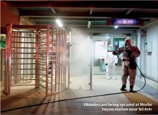  ?? PHOTOS: GETTY IMAGES ?? Disinfecta­nt being sprayed at Moshe Dayan station near Tel Aviv