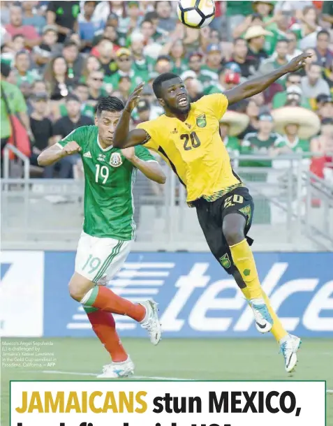  ?? — AFP ?? Mexico’s Angel Sepulveda (L) is challenged by Jamaica’s Kemar Lawrence in the Gold Cup semifinal in Pasadena, California.