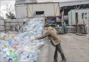  ?? ?? A worker sorting plastic bottles.