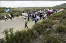  ?? CHRIS CARLSON — THE ASSOCIATED PRESS ?? Demonstrat­ors march to meet Central American migrants traveling in a caravan for a gathering at the border on the beach where the border wall ends in the ocean, Sunday in San Diego.