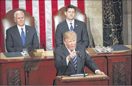  ?? DOUG MILLS / NEW YORK TIMES ?? President Donald Trump, backed by Vice President Mike Pence and House Speaker Paul Ryan, speaks to a joint session of Congress at the Capitol on Tuesday, 40 days into his presidency.