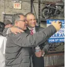  ?? MARY NORKOL/SUN-TIMES ?? Anthony Ciaravino (right) at his election night party Tuesday at Stockyards Garage in Canaryvill­e.