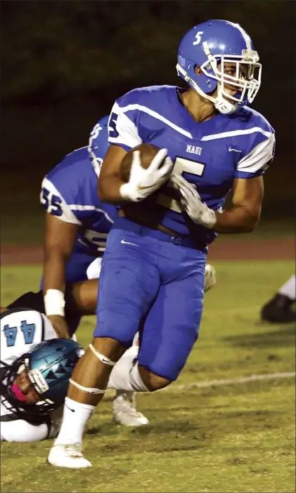  ?? The Maui News / CHRIS SUGIDONO photo ?? Maui High School running back Naia Nakamoto gets past King Kekaulike’s Hanalei Akina in the first quarter of the Sabers’ 41-13 victory over Na Alii on Friday at War Memorial Stadium.