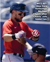  ??  ?? NICE HIT: Alex Cora fistbumps Michael Chavis after Chavis’ solo home run.