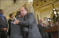  ?? ASSOCIATED PRESS ?? After announcing his support of legislatio­n to change the statute of limitation­s on child sex abuse crimes, state Sen. Daylin Leach, a Montgomery-Delaware County Democrat, facing camera, hugs Rep. Mark Rozzi, himself an abuse victim, at the state Capitol in Harrisburg. A proposal to give victims of child sexual abuse a two-year window to sue over allegation­s that would otherwise be too old to pursue was overwhelmi­ngly approved by the state House on Monday, as supporters cheered from the gallery.