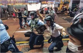  ?? LAM YIK FEI NYT ?? Police officers charge during clashes with protesters after a march near the Canton Road tourist shopping district in Hong Kong on Sunday.