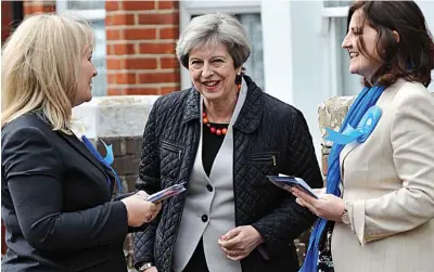  ??  ?? Women at work: Theresa May canvassing with activists in Eastbourne, East Sussex, yesterday