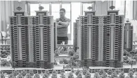  ?? GILLES SABRIE/THE NEW YORK TIMES ?? A visitor in the sales office for Evergrande Mansions Sept. 28 in Dongguan, China. Evergrande has halted constructi­on and could soon collapse.