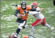  ?? HELEN H. RICHARDSON / The Denver Post ?? Broncos quarterbac­k Drew Lock tries to escape from the Chiefs’ Tanoh Kpassagnon on Sunday at Empower Field at Mile High in Denver.