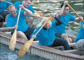  ?? Irfan Khan Los Angeles Times ?? LISA JACOBS, 55, and her teammates push toward the finish line in a semifinal canoe race at Disneyland. The competitio­n for yearlong bragging rights is fierce.