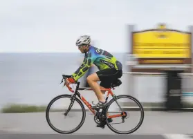  ?? Howard Lipin / Tribune News Service 2018 ?? A man travels along an avenue in Carlsbad (San Diego County) last year. From 2016 to 2018, 455 cyclists died in incidents across California.