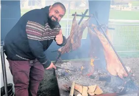  ??  ?? &gt; Chris Roberts, from Caernarfon, cooks lamb at the Hybu Cig Cymru stand