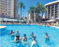  ??  ?? British holidaymak­ers in a hotel pool in Benidorm (left) trying to make the most of their Spanish break just hours after learning that the Government had imposed a 14-day quarantine on anyone returning to the UK from Spain. While some tourists scrambled to find flights to beat the midnight deadline, others were left with the prospect of having to take extra time off work, potentiall­y unpaid. Some of those who were either returning early or had flights already booked just hours after the new rules came into force left from Malaga Airport on the Costa del Sol yesterday (left).