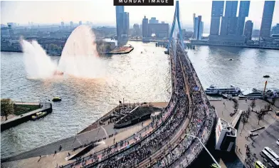  ?? | EPA ?? RUNNERS cross the Erasmus bridge during the 2019 39th NN Marathon Rotterdam in Rotterdam, Netherland­s, yesterday.