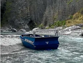  ??  ?? The jet boat at Skippers Canyon after a crash which left 10 injured on Saturday.