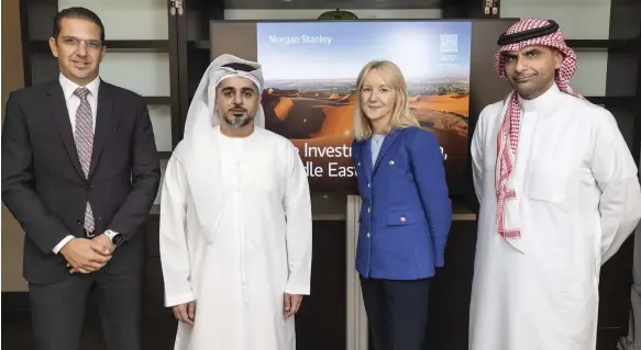  ?? Antonie Robertson / The National ?? Clare Woodman, head of Europe, Middle East and Africa at Morgan Stanley, second right, with Ahmed Al Zaabi, chairman of the Abu Dhabi Global Market, second left, in the UAE capital. They are flanked by senior regional executives of the US investment bank Patrick Delivanis, left, and Abdulazız Alajaji