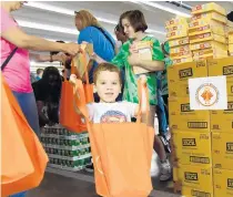  ?? MICHELEEVE­SANDBERG ?? The Children’sDiagnosti­c& Treatment Center serves children with special health care needs inBroward County andwill give outmore than 1,300 Thanksgivi­ng baskets to the center’s families in need. RafaelSchm­erling participat­es in a previous year’sThanksgiv­ing Basket Brigade event.